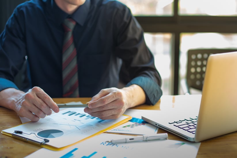 business-documents-on-office-table-and-graph-business-with-social-network-diagram-and-man-working-in-the-background