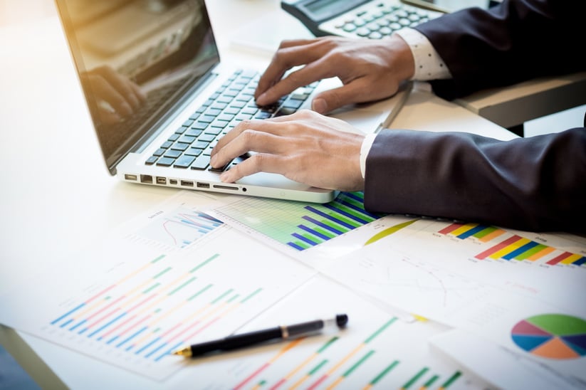 working-process-startup-businessman-working-at-the-wood-table-with-new-finance-project-modern-notebook-on-table-pen-holding-hand